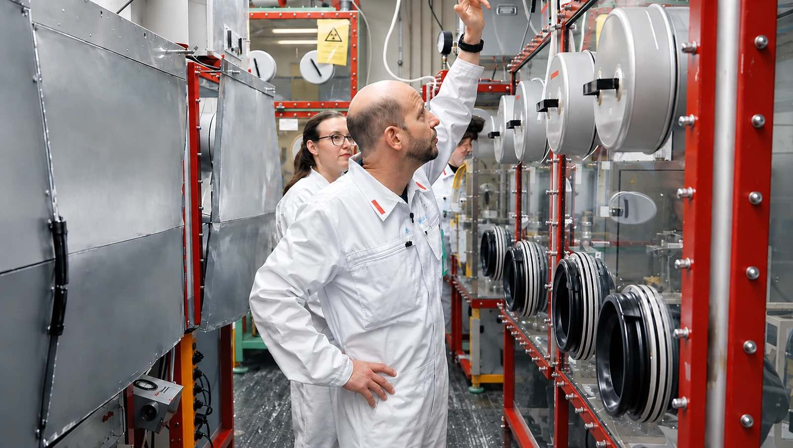Colleagues working together at laboratory equipment.